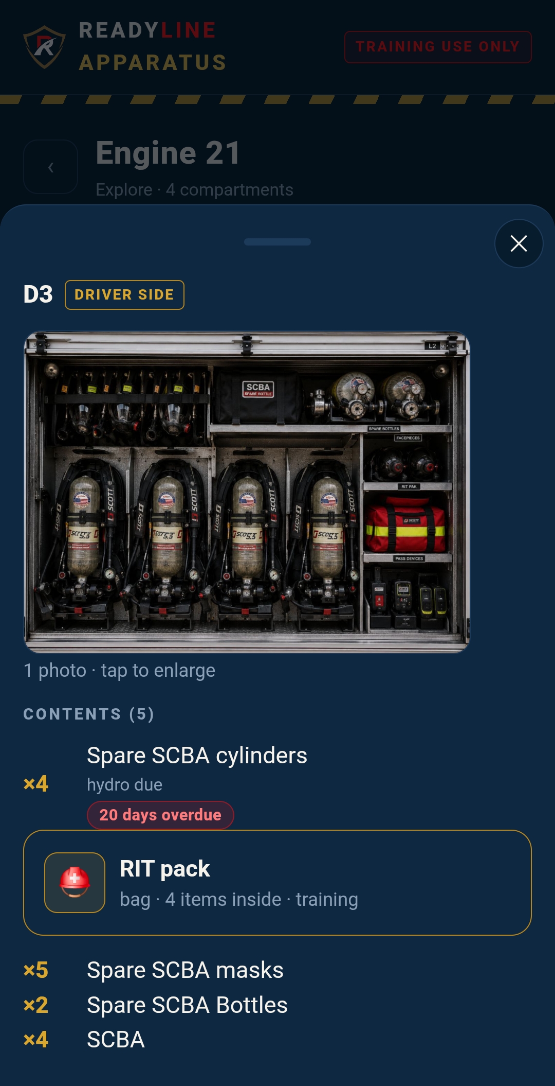 An opened compartment showing a photo of SCBA gear and a tagged contents list